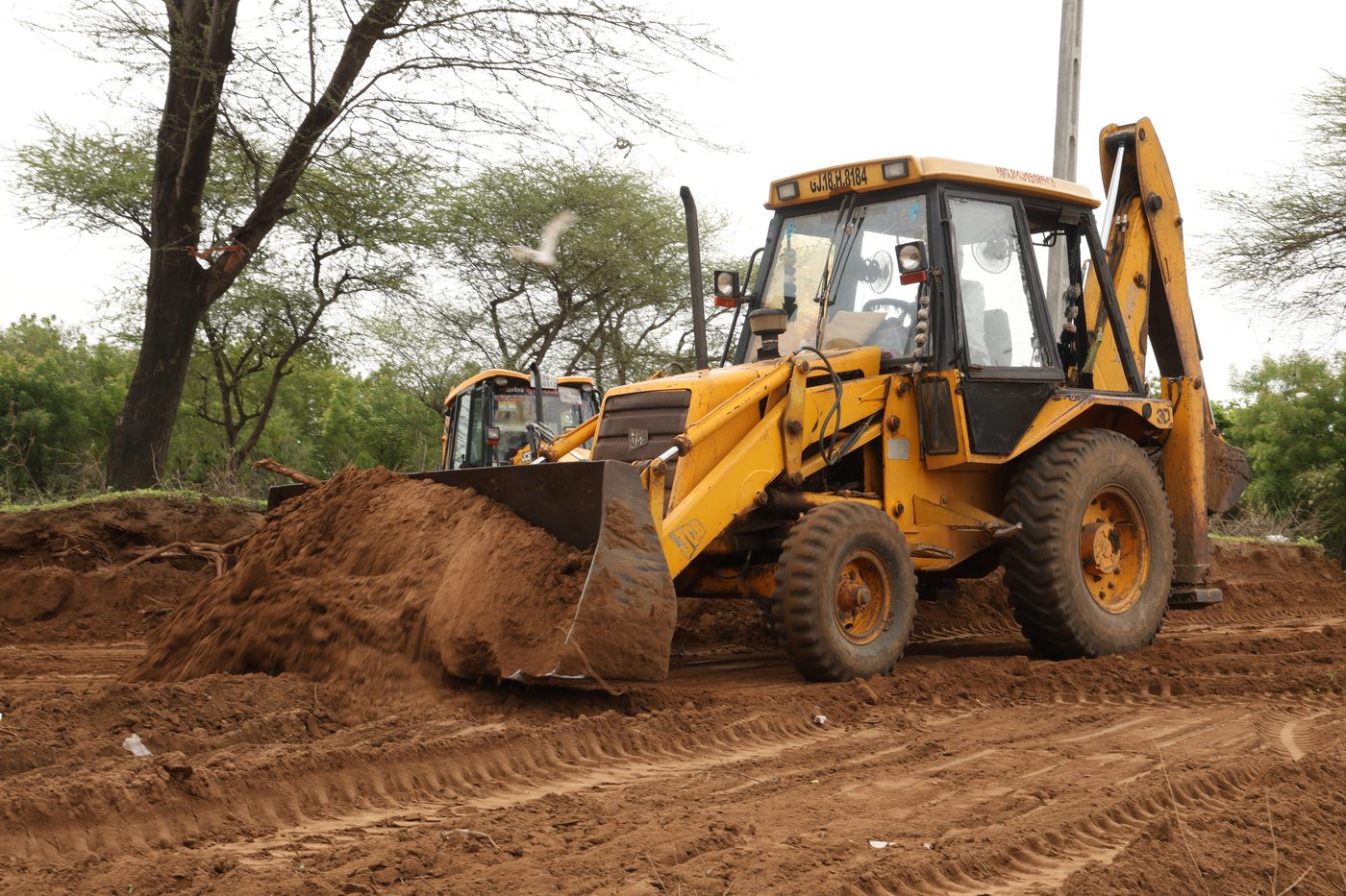 JCB excavator shaping and grading the ground at Jaspur Oxygen Park