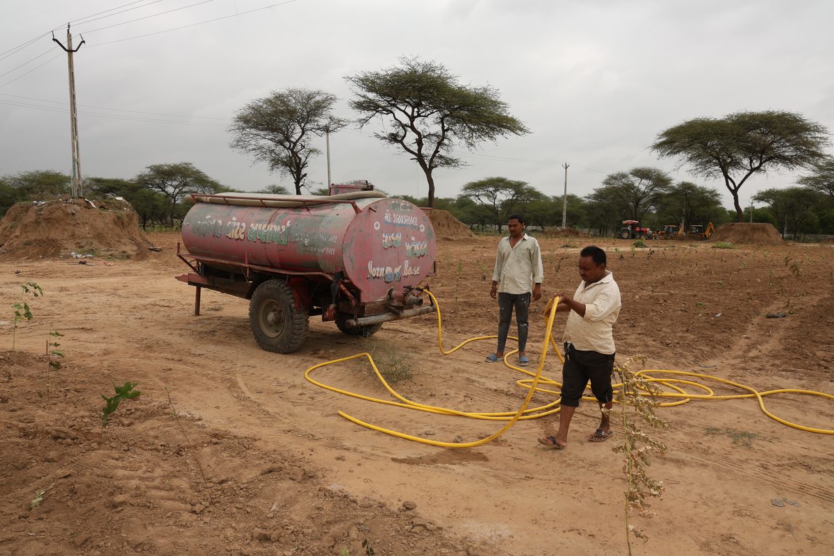 Workers irrigating the plantation from a water tanker at Jaspur