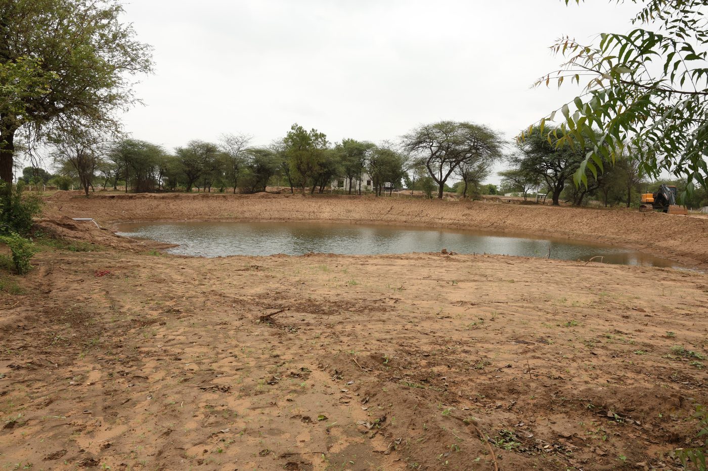 A water-retention pond holding rainwater at the Jaspur site