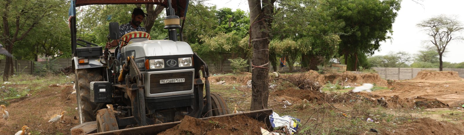 A tractor grading and preparing the ground at Lapkaman as part of the site's contour and water-management earthworks
