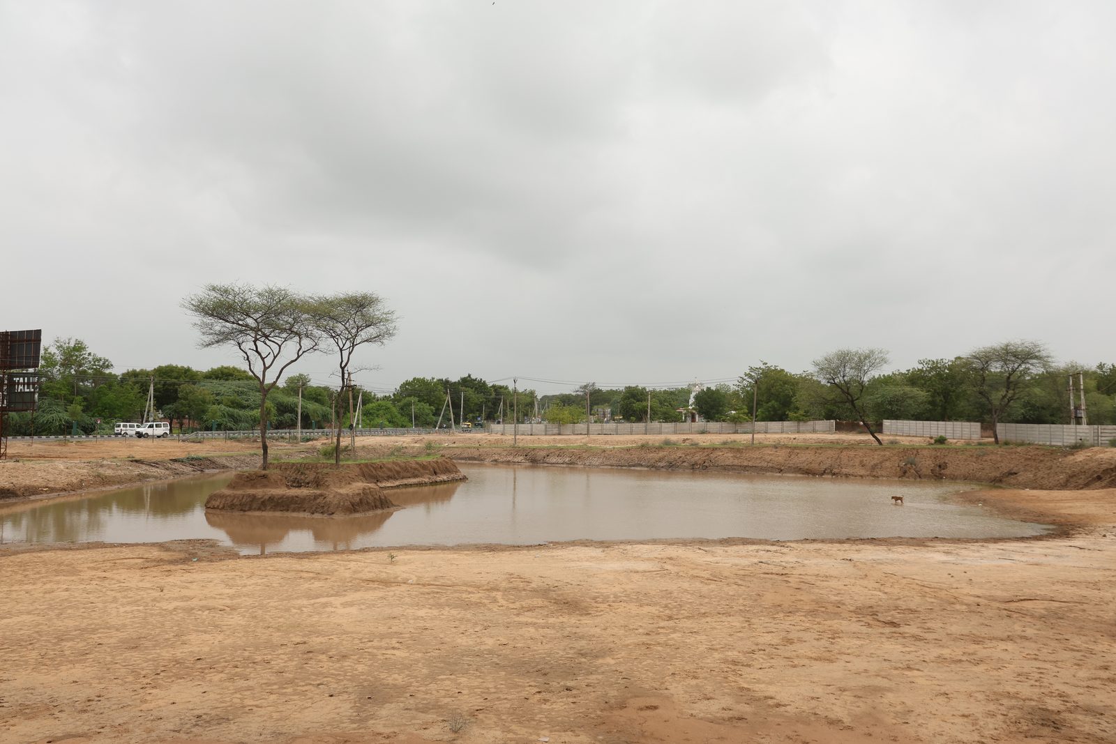 Wide view across the Lapkaman Oxygen Park site with the excavated lake and native trees